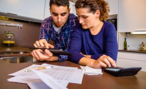 Couple reviewing their accounts with a digital tablet