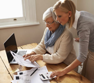 Daughter reviews bills with her senior mother