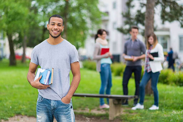 College student carrying books on campus