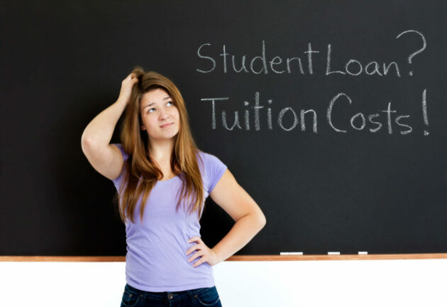 Woman contemplates blackboard: Student Loan? Tuition Costs! Why do women hold more student debt?