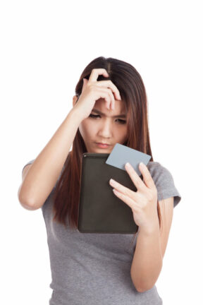 Teen contemplates credit card bill on a tablet