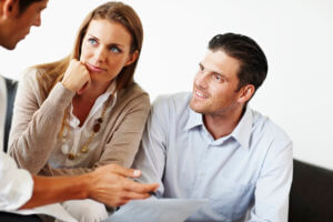 Couple listens intently to certified credit counselor as they review their options for debt relief