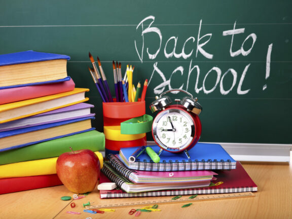 back to school shopping; back to school supplies in front of a chalkboard