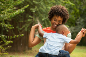 money help for single parents; smiling mom with child