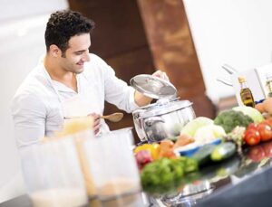 Man cooking a meal at home to maintain a food budget