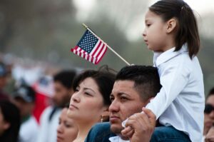 A Hispanic family watches a parade in the U.S.