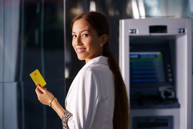 Hispanic woman at an ATM