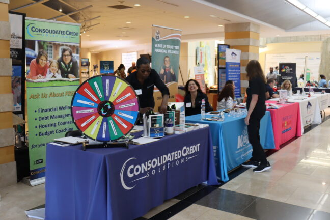 Consolidated Credit information booth with staff and a prize wheel at an event