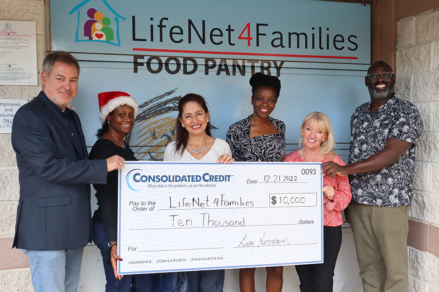 Consolidated Credit representatives presenting an oversized check to LifeNet4Families Food Pantry staff